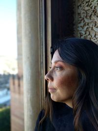 Woman looking through window