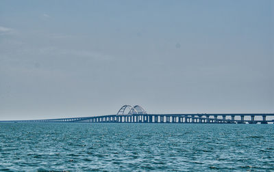 Bridge over sea against sky