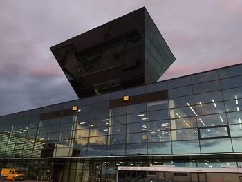 Low angle view of modern building against sky at dusk