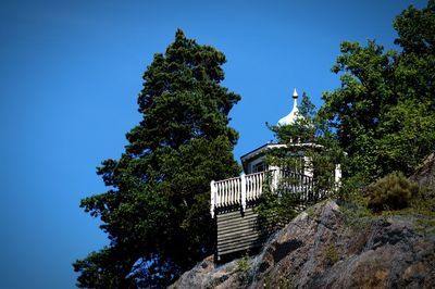 Low angle view of built structure on mountain against clear sky