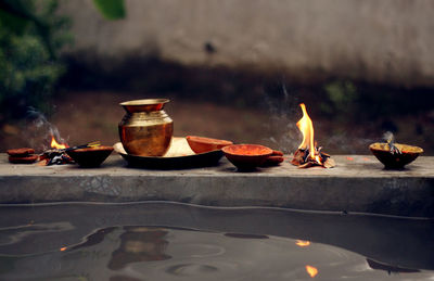 Flame and containers by water