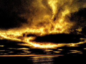 Scenic view of dramatic sky over sea during sunset