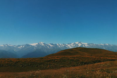 Scenic view of landscape against blue sky