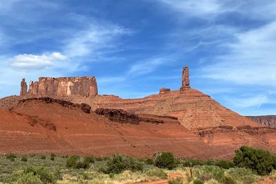 View of rock formations on landscape against cloudy sky