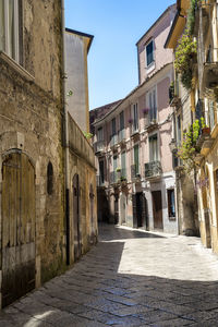 Street amidst buildings in town against sky