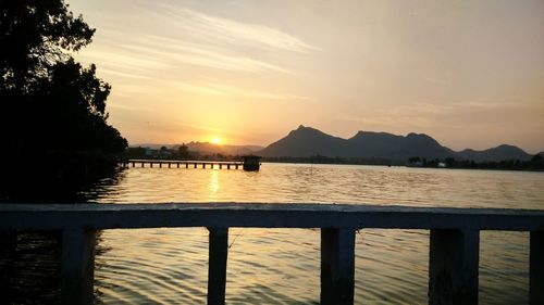 Scenic view of lake at sunset