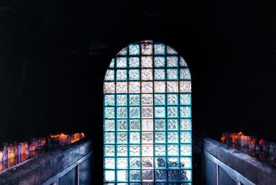 Illuminated building seen through window