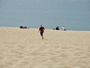 People on beach against sea