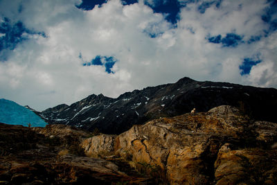 Scenic view of mountains against cloudy sky