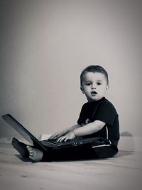 Portrait of cute boy sitting at home