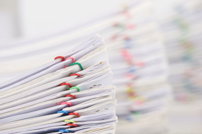 Close-up of stacked files on table in office