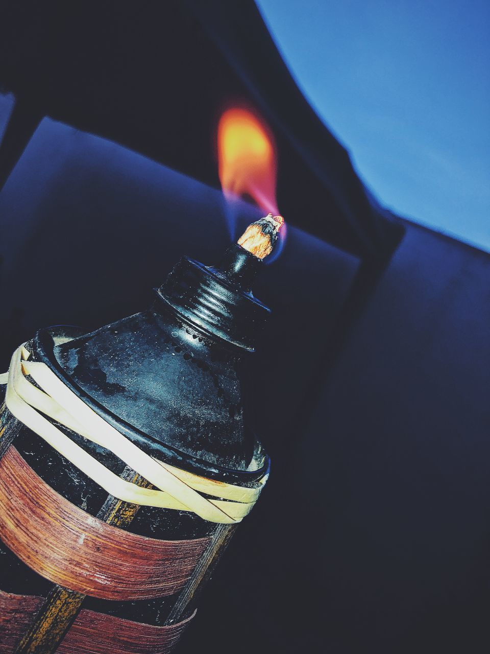 HIGH ANGLE VIEW OF LIT CANDLE IN GLASS