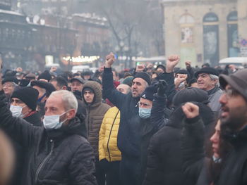 Group of people looking at city in winter