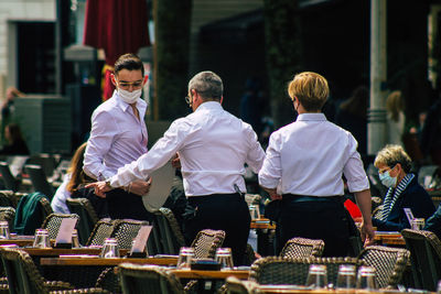 Rear view of people standing outdoors