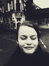 Close-up portrait of young woman in city