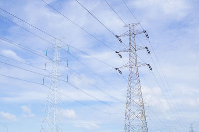 Low angle view of electricity pylon against sky
