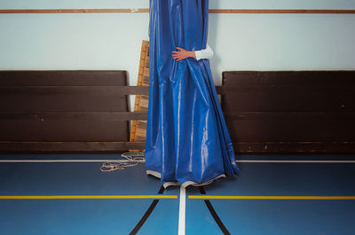  teenage boy at school graduation standing on floor at school