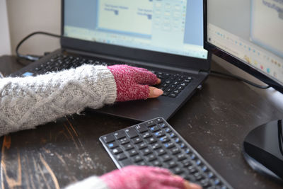 Hands of a woman working from home in winter