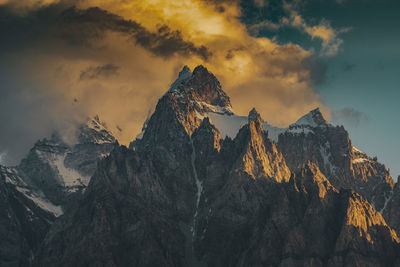 Panoramic view of snowcapped mountains against sky during sunset