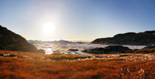 Scenic view of mountains against clear sky during sunset