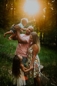 Vertical portrait of biracial family looking at each other