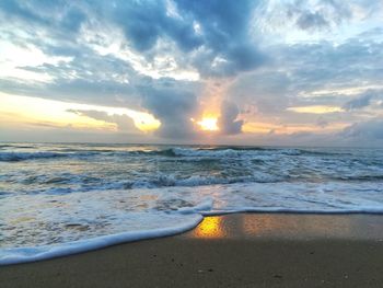 Scenic view of beach against sky during sunset