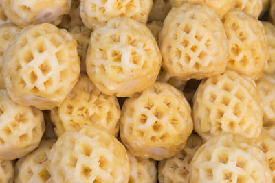 Directly above shot of peeled pineapples for sale at market stall