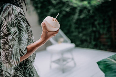 Midsection of woman holding ice cream