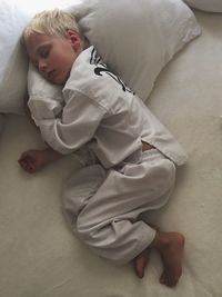 Directly above shot of boy sleeping on bed