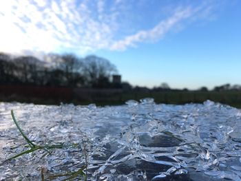 Close-up of frozen lake against sky