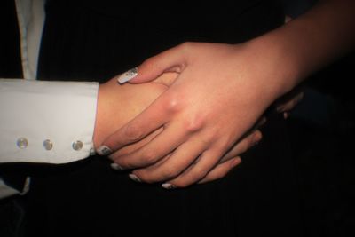 Cropped image of couple with holding hands
