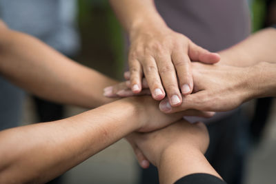 Close-up of friends stacking hands