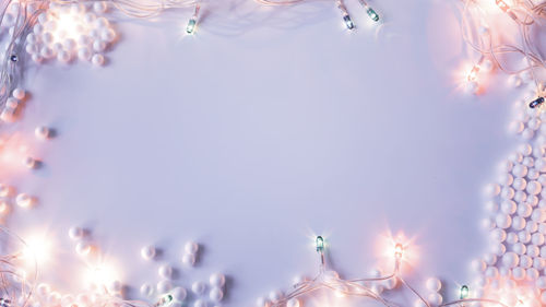 Low angle view of illuminated christmas lights against sky