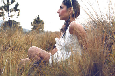 Woman standing on grassy field