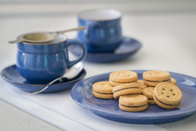 Some cookies on a blue two cups.