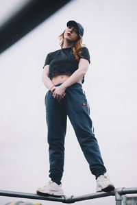 Portrait of young woman standing on pipeline