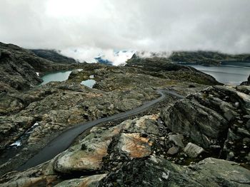 High angle view of mountain road against cloudy sky