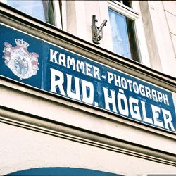 Low angle view of road sign against building