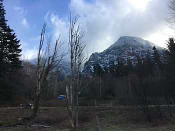 Scenic view of mountains against cloudy sky