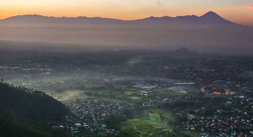 High angle view of cityscape against sky at sunset