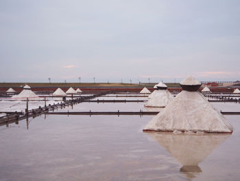 Built structure by lake against sky