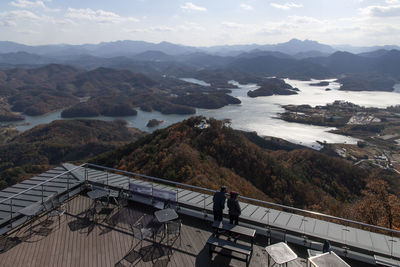 High angle view of rooftop and mountains against sky