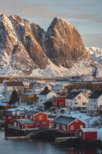 Aerial view of townscape by mountain against sky