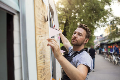 Side view of owner hanging bunting on food truck