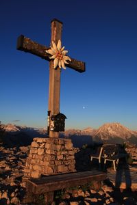 Cross against clear blue sky