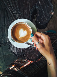 Woman holding coffee cup