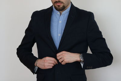 Midsection of a young man against white background