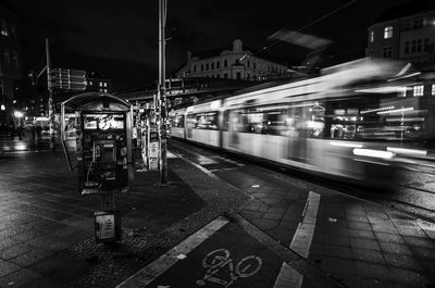 Blurred motion of tram on street in city at night