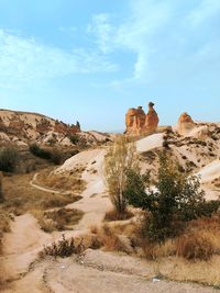 Rock formations on landscape against sky