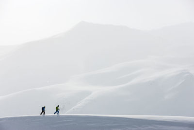 People on snowcapped mountain